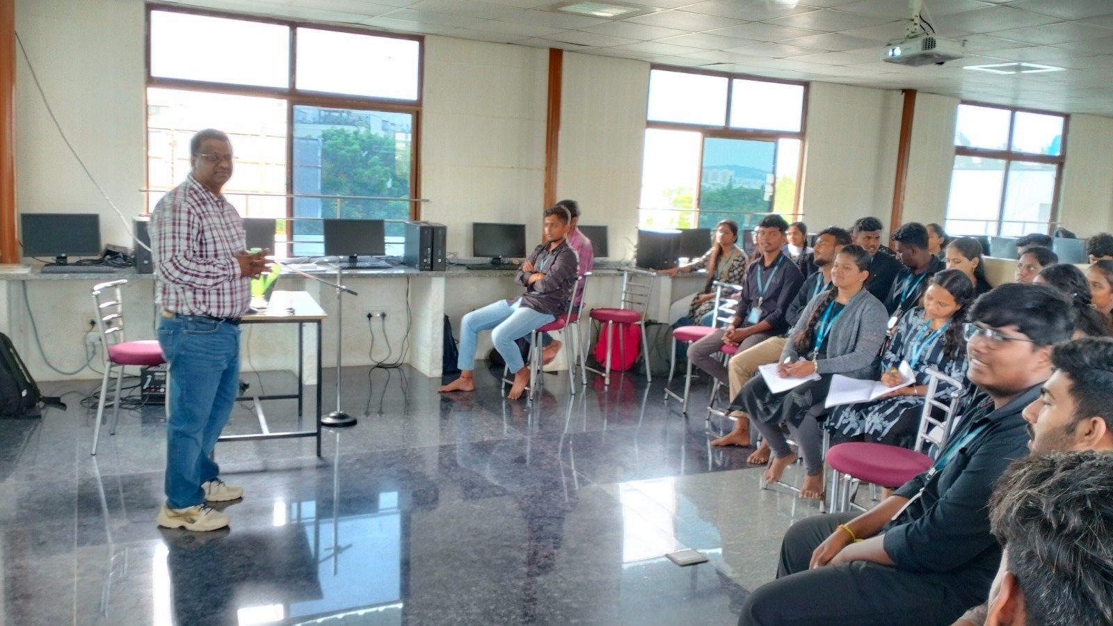 Trainer running a session in the computer lab with students seated