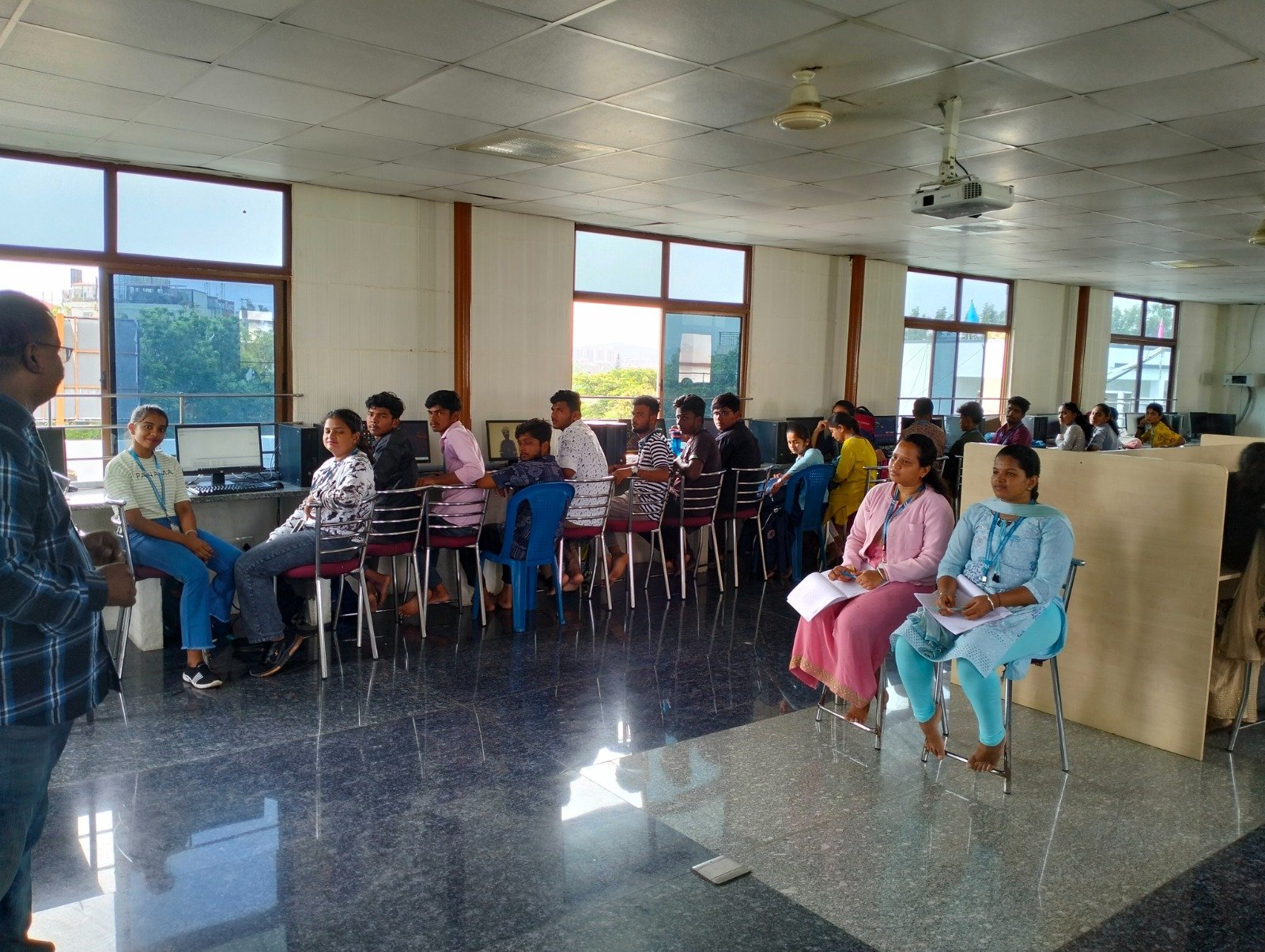 Students seated in rows taking notes during a group session